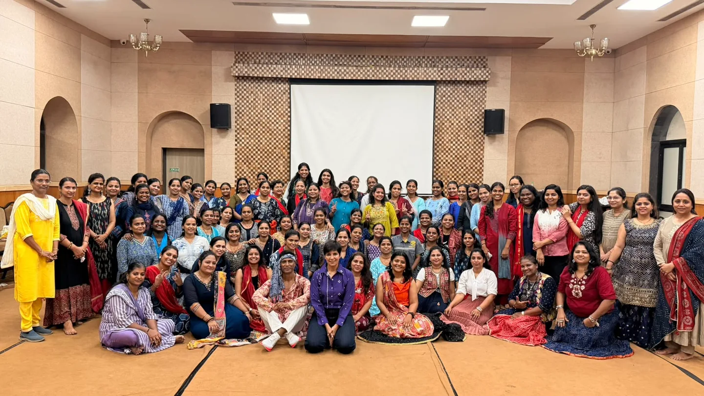 Participants gathered for a group photograph at an indoor Tsukuru event.