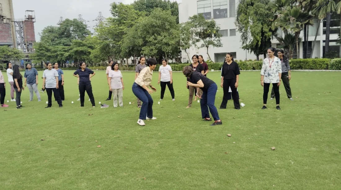 Participants taking part in a group activity on a lawn at a Tsukuru event.