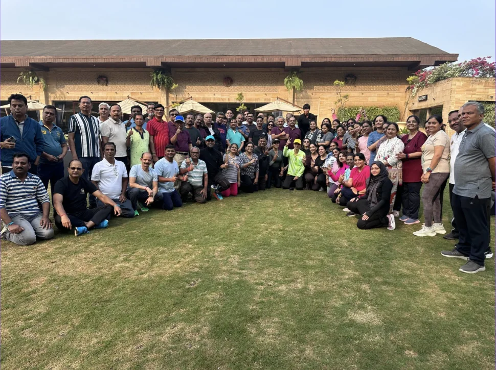 A large group gathered outdoors for a Tsukuru wellness event.