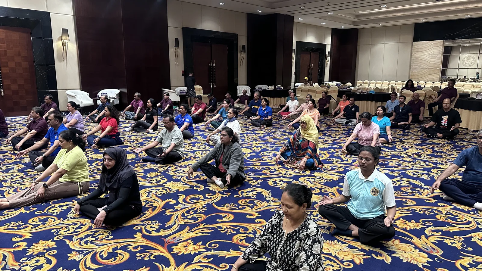 Participants seated on the floor during an indoor group wellbeing activity.